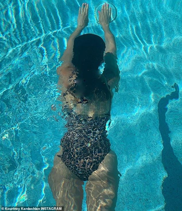 Kourtney Kardashian shows off her bomb figure in a leopard-print Good American swimsuit 141