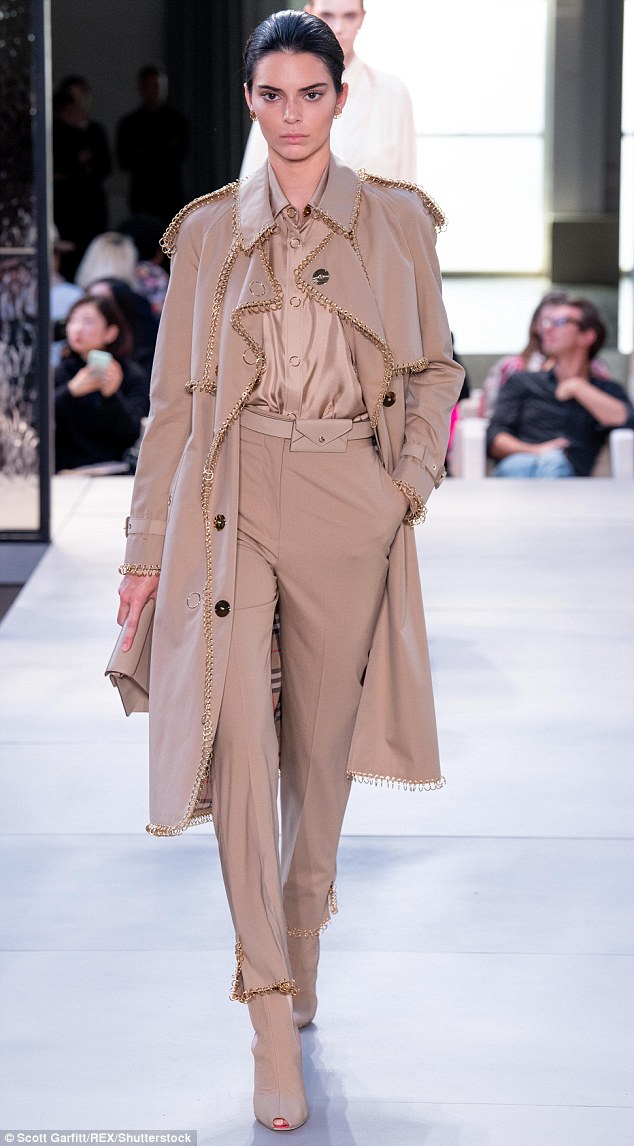 Look: Kendall took the catwalk in an all-beige outfit including a trench embellished with chains — a modern take on Burberry's classic design